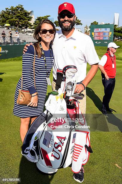 Annie Verret, girlfriend of Jordan Spieth of Team USA, and Spieth's caddie Michael Greller pose for a photo during the first round of The Presidents...