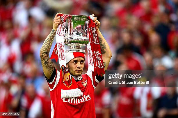 Jack Wilshere of Arsenal celebrates victory with the trophy after the FA Cup with Budweiser Final match between Arsenal and Hull City at Wembley...