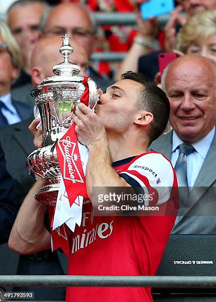 Captain Thomas Vermaelen of Arsenal kisses the trophy in celebration as FA chairman Greg Dyke looks on after the FA Cup with Budweiser Final match...