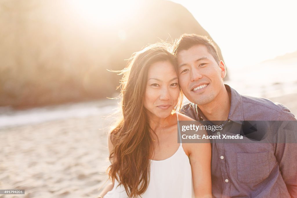 Portrait of Asian couple relaxing on beach