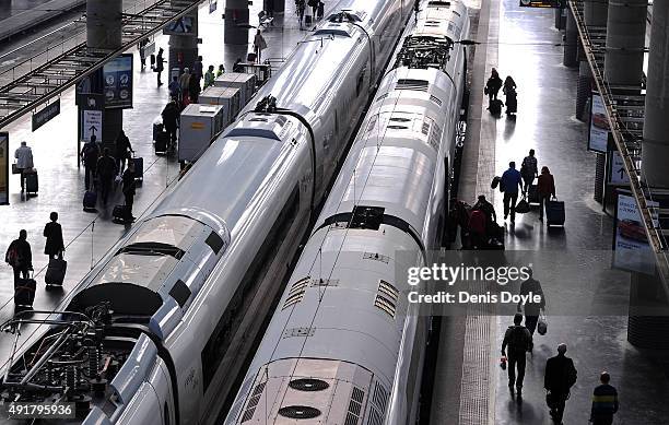 Passengers board AVE high-speed trains at Atocha train station on October 8, 2015 in Madrid, Spain. A total of 20 trains and 7,000 travellers were...