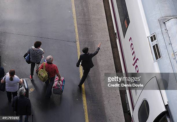 Passengers board AVE high-speed trains at Atocha train station on October 8, 2015 in Madrid, Spain. A total of 20 trains and 7,000 travellers were...