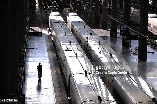 Person walks past a departing AVE high-speed train at Atocha train station on October 8, 2015 in Madrid, Spain. A total of 20 trains and 7,000...