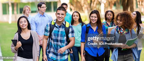 diverse high school or college students walking on campus - cute college girl stockfoto's en -beelden