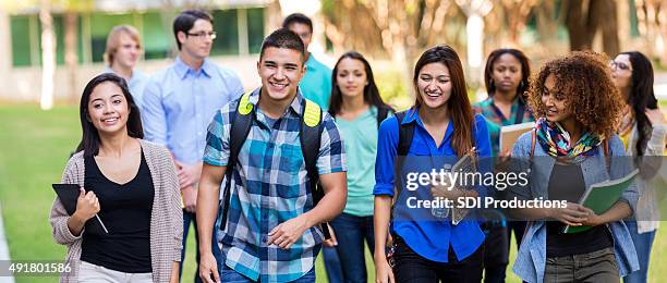 diverse high school or college students walking on campus - college students diverse stock pictures, royalty-free photos & images