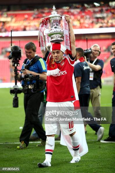 Jack Wilshere of Arsenal holds the Cup during the FA Cup with... News