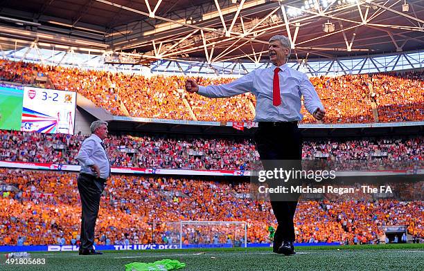 Arsene Wenger, manager of Arsenal celebrates next to Steve Bruce, manager of Hull City during the FA Cup with Budweiser Final match between Arsenal...