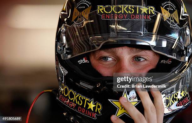 Dylan Kwasniewski, driver of the Up & Up Chevrolet, waits in the garage during practice for the NASCAR Nationwide Series Get To Know Newton 250...