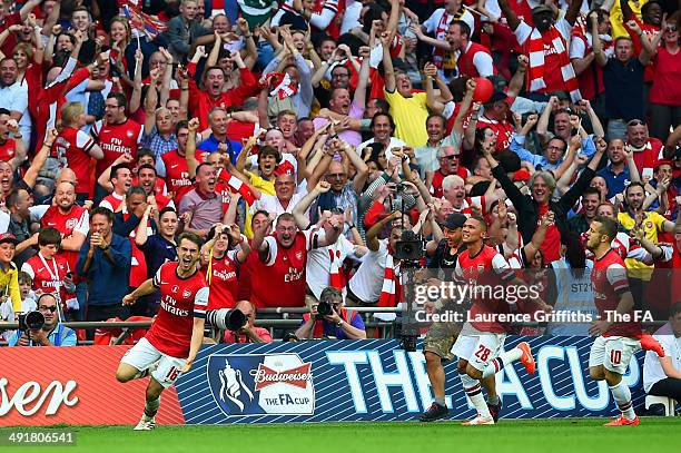 Aaron Ramsey of Arsenal celebrates with team-mates after scoring their third goal during the FA Cup with Budweiser Final match between Arsenal and...