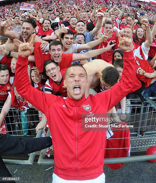 Lukas Podolski celebrates with the Arsenal fans after the FA Cup Final between Arsenal and Hull City at Wembley Stadium on May 17, 2014 in London,...