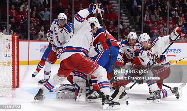 Peter Budaj, Thomas Vanek and David Desharnais of the Montreal Canadiens defend the net against Brian Boyle, Carl Hagelin and Anton Stralman of the...