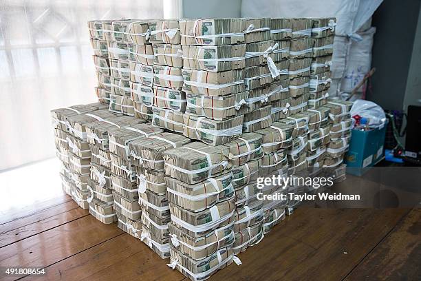 Kyat notes are piled on a table at the KBZ Bank main office on October 8, 2015 in Yangon, Burma. In Burma, the most widely deposited bank note is...