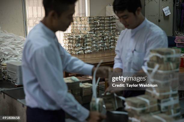 Employees bundle deposited kyat at the KBZ Bank main office on October 8, 2015 in Yangon, Burma. In Burma, the most widely deposited bank note is...