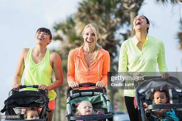 multi-racial mothers with babies in jogging strollers - baby pram in the park bildbanksfoton och bilder