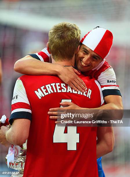 Santi Cazorla of Arsenal celebrates with Per Mertesacker of Arsenal during the FA Cup with Budweiser Final match between Arsenal and Hull City at...