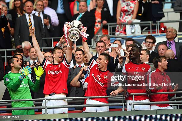 Lukasz Fabianski, Per Mertesacker, Laurent Koscielny, Yaya Sanogo and Nacho Monreal of Arsenal celebrate with the FA Cup following victory in the FA...