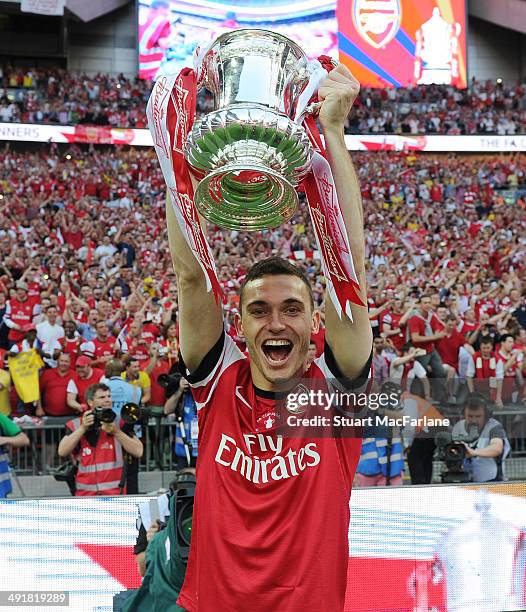 Arsenal captain Thomas Vermaelen celebrates after the FA Cup Final between Arsenal and Hull City at Wembley Stadium on May 17, 2014 in London,...