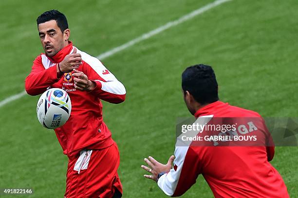 Tonga's fly half Kurt Morath passes the ball during a captain's run training session at Saint James' Park stadium in Newcastle-upon-Tyne, northeast...