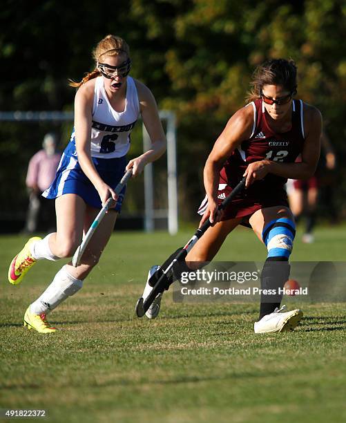 Greely vs Kennebunk field hockey. Chloe Smith of Kennebunk, left, moves the ball up the field as Alyssa Coyne of Greely defends during the first half.