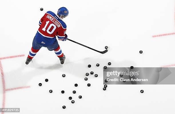 Henrik Samuelsson of the Edmonton Oil Kings gets the pucks ready in the warm-up prior to play against the Guelph Storm in Game Two of the 2014...