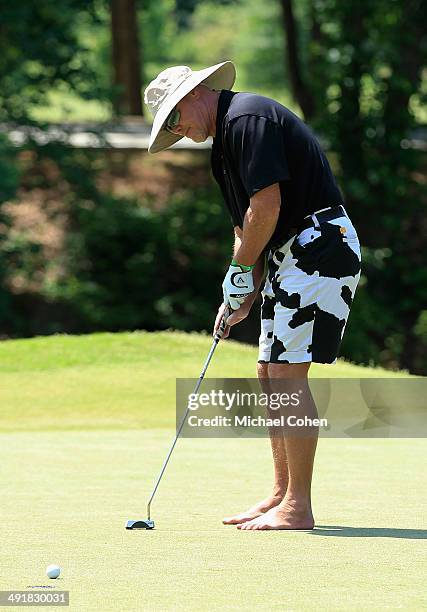 Celebrity golfer Jim McMahon strokes a putt on the fourth green during the third round of the BMW Charity Pro-Am Presented by SYNNEX Corporation held...