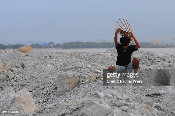 Students of the Theater Hands Muslim University of Indonesia Makassar perform the "Rite Chart" at the site of the Gulf coastal reclamation Palu. The...