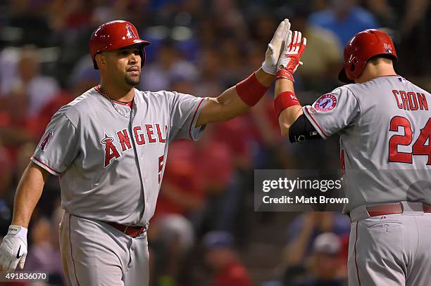 Albert Pujols and C.J. Cron of the Los Angeles Angels of Anaheim high-five while celebrating after Pujols hit a solo home run during the sixth inning...