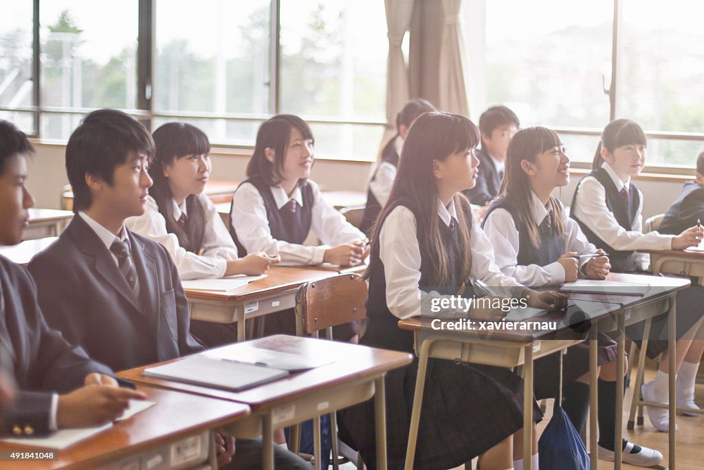 Japanese students listening to the teacher in the classroom