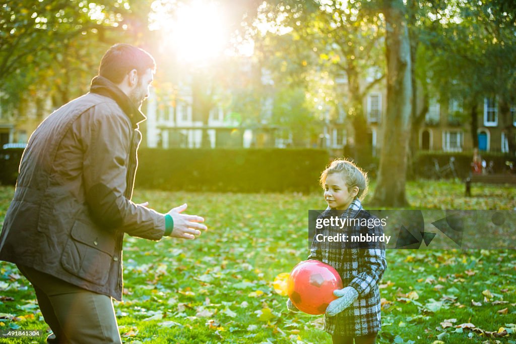Father and daughter having fun in park