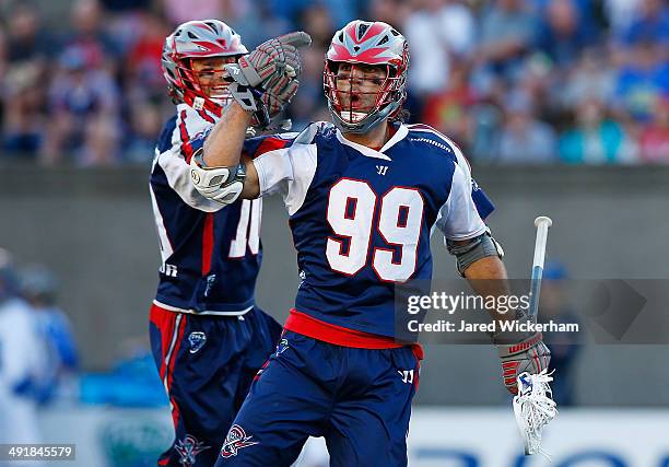 Paul Rabil of the Boston Cannons celebrates his goal with teammate Stephen Berger in the first half against the Charlotte Hounds during the game at...