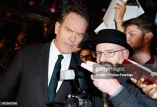 Actor Bryan Cranston with a fan dressed up as his Breaking Bad character Walter White as he attends the "Trumbo" premiere during the BFI London Film...