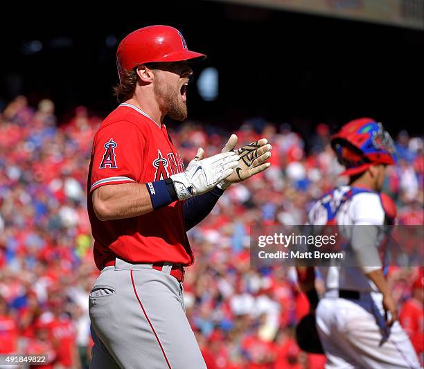 Pinch runner Collin Cowgill of the Los Angeles Angels of Anaheim celebrates after scoring on a RBI single by Carlos Perez during the ninth inning of...