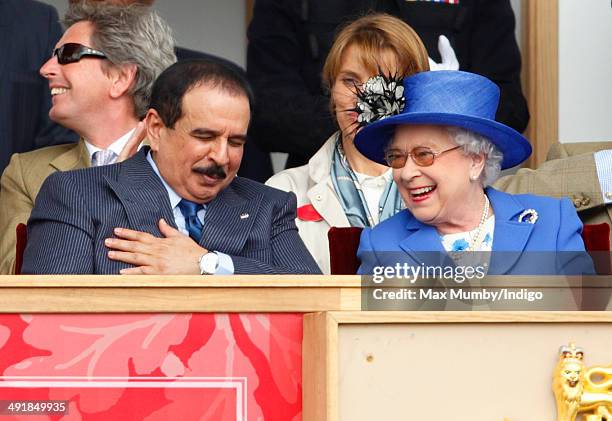 Hamad bin Isa Al-Khalifa, King of Bahrain and Queen Elizabeth II watch the Services Team Jumping Event from the Royal Box on day 4 of the Royal...