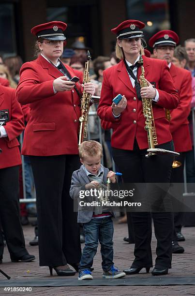 Young boy plays with his toy saxophone while waiting for King Willem-Alexander and Queen Maxima of The Netherlands visiting the former mining region...