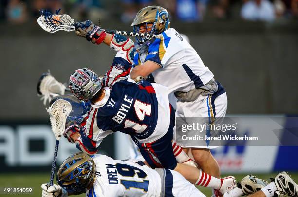 Adam Ghitelman of the Charlotte Hounds hits Ryan Boyle of the Boston Cannons in the second half during the game at Harvard Stadium on May 17, 2014 in...