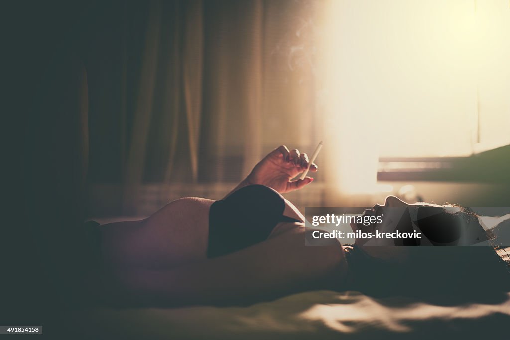 Girl smoking in bedroom