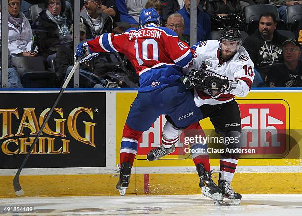 Nick Ebert of the Guelph Storm slams into Henrik Samuelsson of the Edmonton Oil Kings in Game Two of the 2014 Mastercard Memorial Cup at Budweiser...