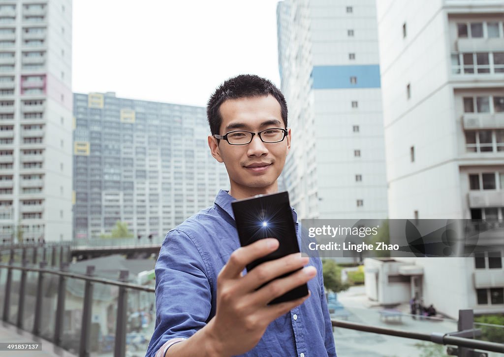 Asian man holding a mobile phone