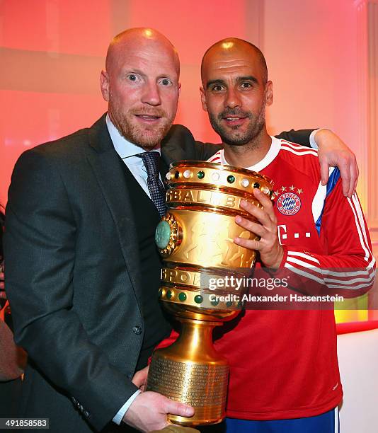 Josep Guardiola , head coach of Bayern Muenchen holds the German DFB Cup Trophy with his sporting director Matthias Sammer during the FC Bayern...