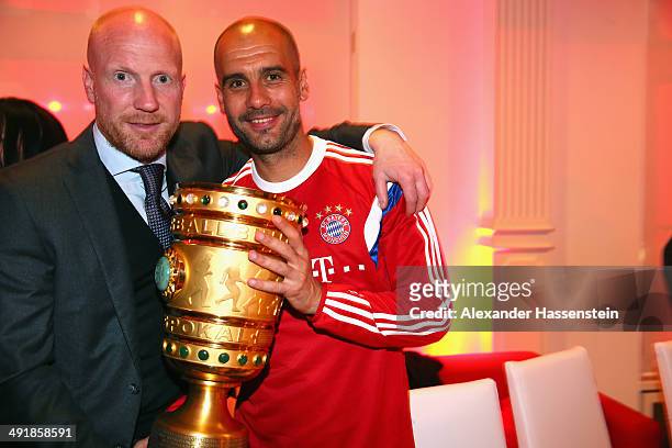 Josep Guardiola , head coach of Bayern Muenchen holds the German DFB Cup Trophy with his sporting director Matthias Sammer during the FC Bayern...