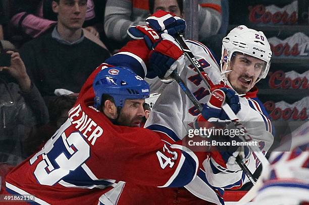 Mike Weaver of the Montreal Canadiens moves Chris Kreider of the New York Rangers from the crease in Game One of the Eastern Conference Final during...