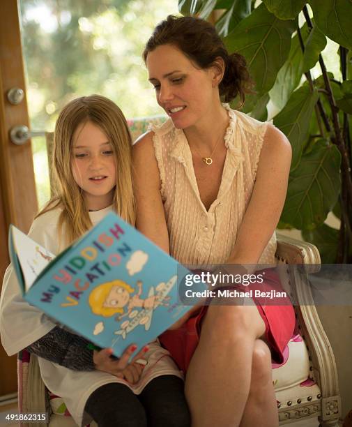 Ione Skye reads to a guest from her book "My Yiddish Vacation" at her book launch and benefit on May 17, 2014 in Los Angeles, California.