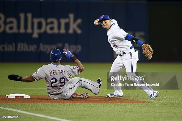Troy Tulowitzki of the Toronto Blue Jays tags out Adrian Beltre of the Texas Rangers hit by Prince Fielder of the Texas Rangers in the first inning...
