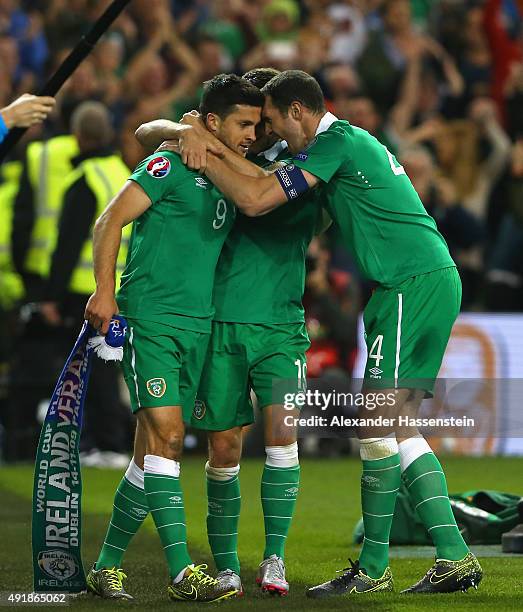 Shane Long of Republic of Ireland celebrates scoring the opening goal with Robbie Brady and John O'Shea of Republic of Ireland during the UEFA EURO...