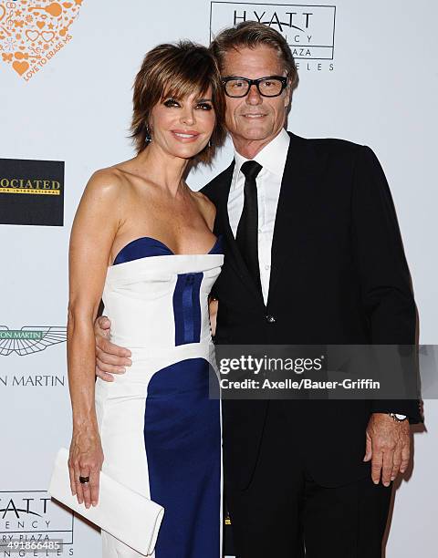 Actress Lisa Rinna and Harry Hamlin arrive at the 21st Annual Race To Erase MS Gala at the Hyatt Regency Century Plaza on May 2, 2014 in Century...