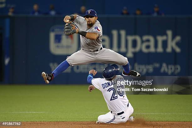 Rougned Odor of the Texas Rangers collides with Josh Donaldson of the Toronto Blue Jays after taggin him out in the fourth inning during game one of...