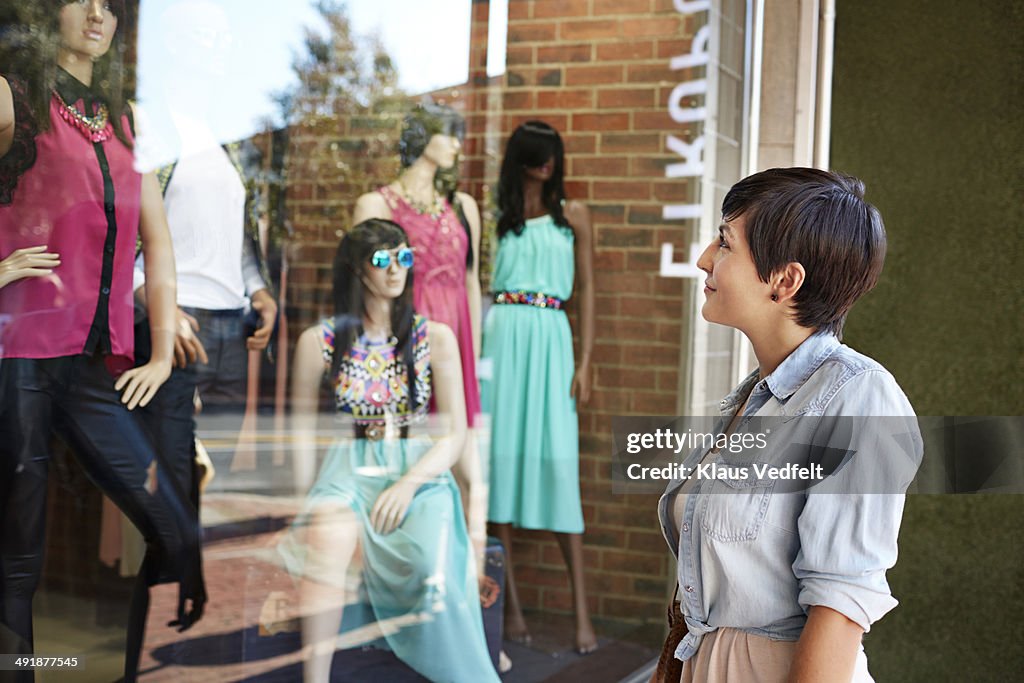 Cute woman window shopping