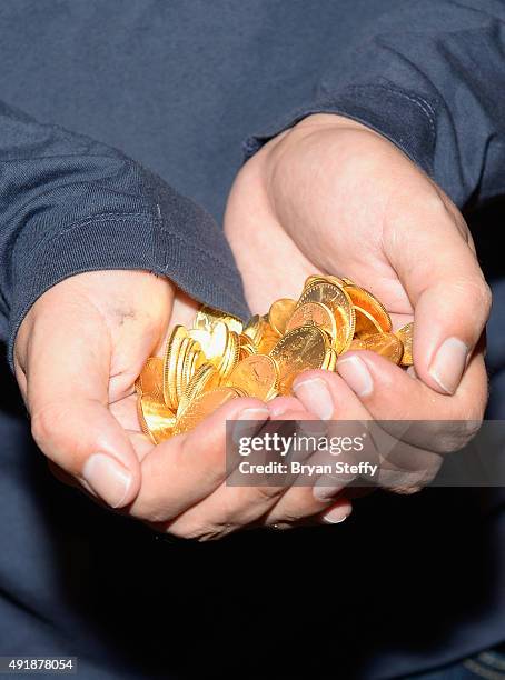 Froylan Moreno del Rio, hand and coin detail, collects the grand prize of USD 500,000 worth of gold after solving the first interactive puzzle from...