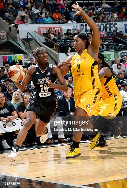 Shameka Christon of the San Antonio Stars drives against Courtney Paris of the Tulsa Shock at the AT&T Center on May 17, 2014 in San Antonio, Texas....