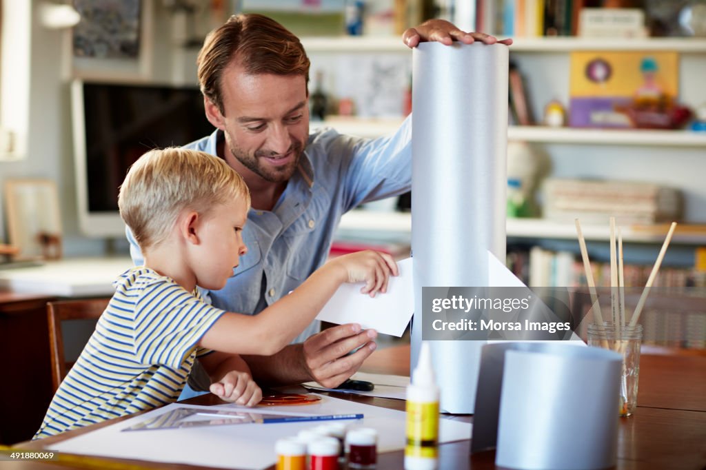 Father and son building rocket